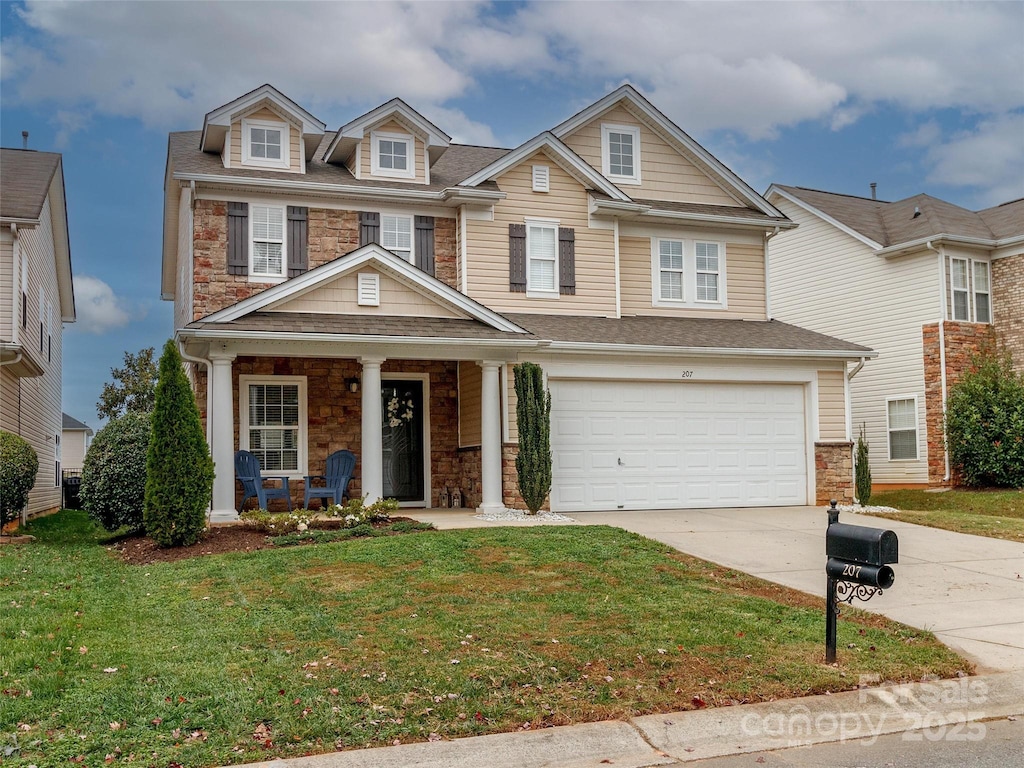 view of front of home featuring a front lawn and a garage