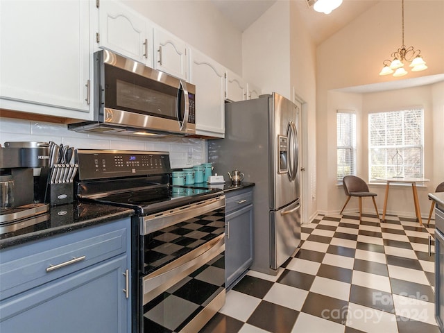 kitchen featuring backsplash, pendant lighting, a chandelier, white cabinets, and appliances with stainless steel finishes