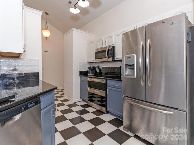 kitchen with pendant lighting, blue cabinets, appliances with stainless steel finishes, tasteful backsplash, and white cabinetry