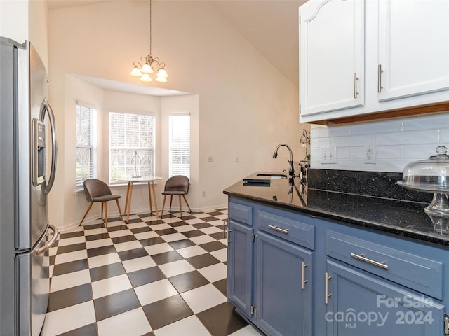 kitchen featuring white cabinetry, sink, blue cabinets, stainless steel fridge, and pendant lighting