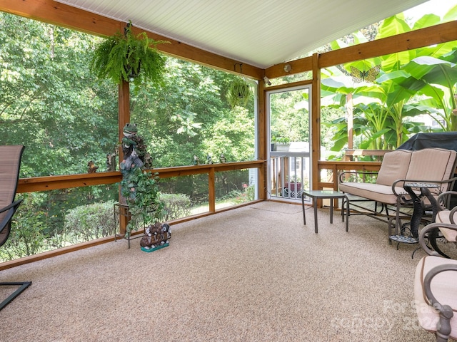 sunroom / solarium featuring vaulted ceiling