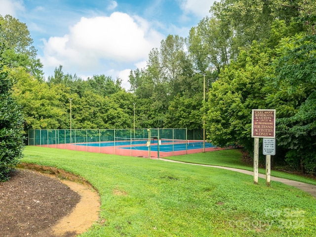 view of sport court featuring a yard