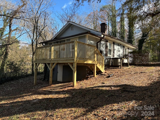 back of property featuring a wooden deck