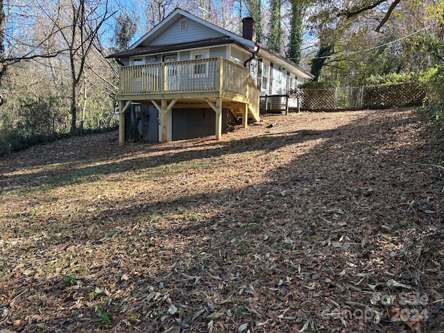 rear view of house with a wooden deck