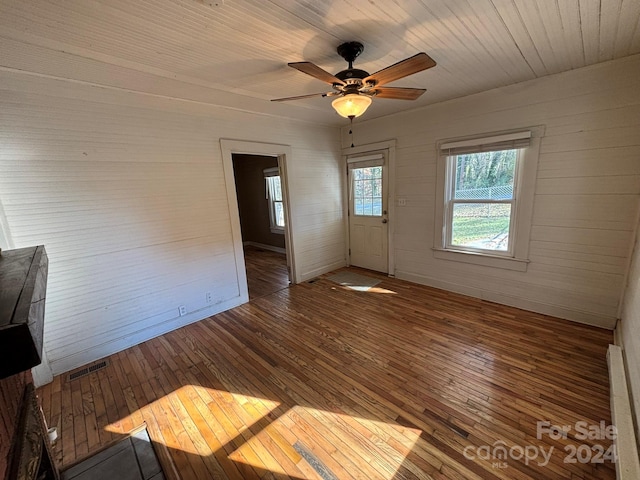 interior space with ceiling fan, wood-type flooring, and wooden ceiling