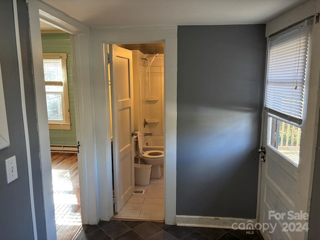 interior space featuring dark tile patterned floors and a baseboard radiator