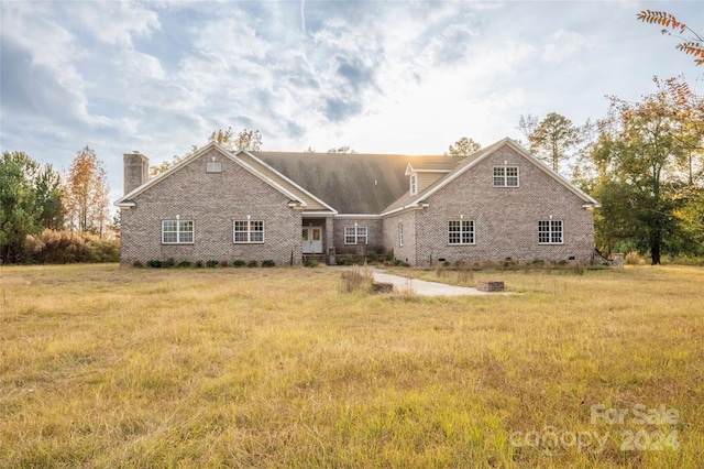 back of house with a lawn