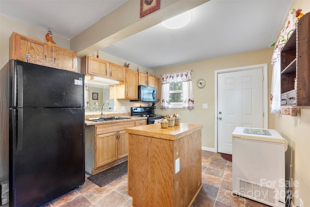 kitchen with black appliances, a center island, sink, and light brown cabinetry