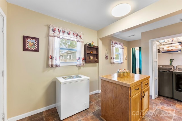 kitchen with separate washer and dryer and a kitchen island