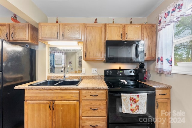 kitchen with black appliances, sink, and light brown cabinetry