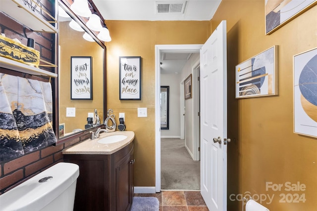 bathroom featuring tile patterned floors, vanity, and toilet