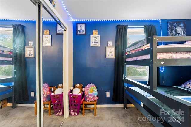 carpeted bedroom featuring multiple windows