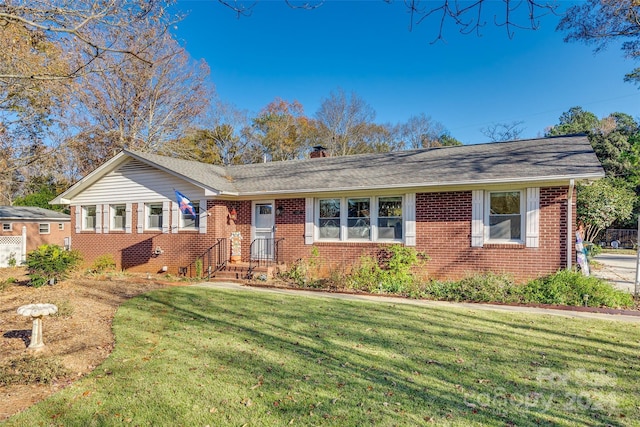 ranch-style home with a front lawn