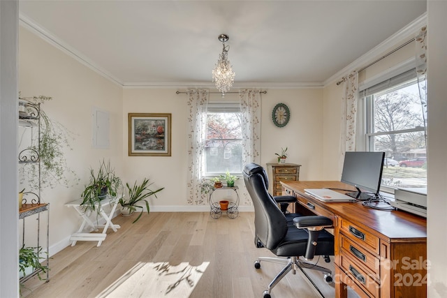 office area featuring a chandelier, ornamental molding, light hardwood / wood-style floors, and a healthy amount of sunlight