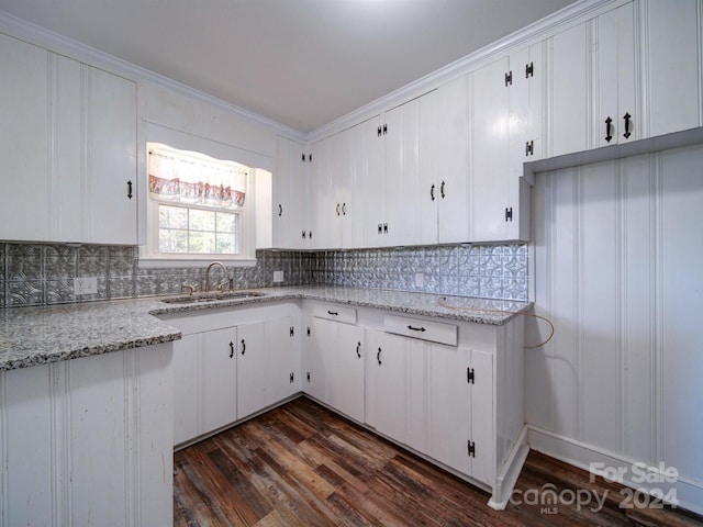 kitchen featuring backsplash, dark hardwood / wood-style flooring, white cabinetry, and sink