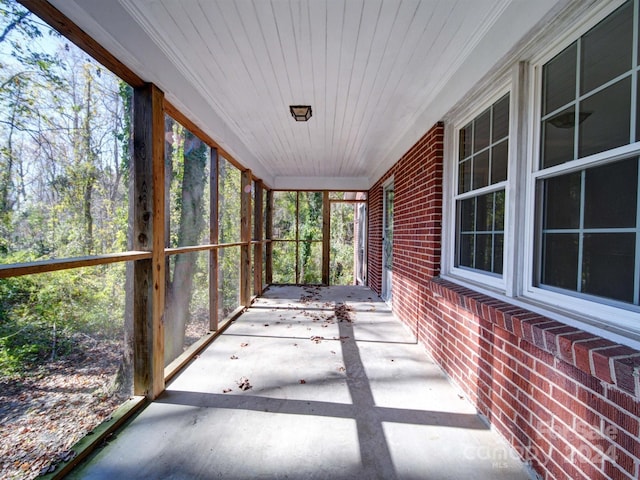 unfurnished sunroom featuring wooden ceiling