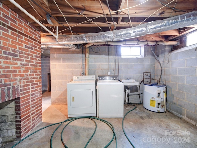 laundry area featuring washing machine and dryer and water heater