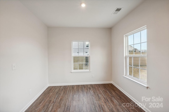 empty room featuring dark hardwood / wood-style flooring