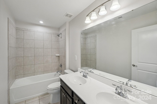 full bathroom featuring toilet, tile patterned flooring, vanity, and tiled shower / bath