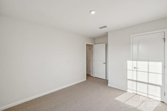 unfurnished bedroom featuring light colored carpet