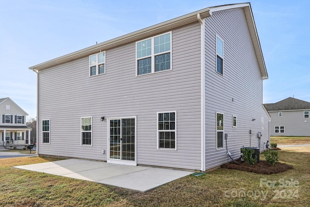 rear view of house featuring a yard and a patio