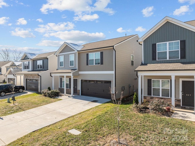 view of front of property featuring a front yard and a garage