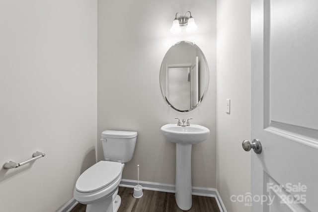 bathroom featuring sink, toilet, and hardwood / wood-style floors