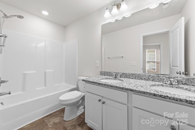 full bathroom featuring vanity, tub / shower combination, and toilet