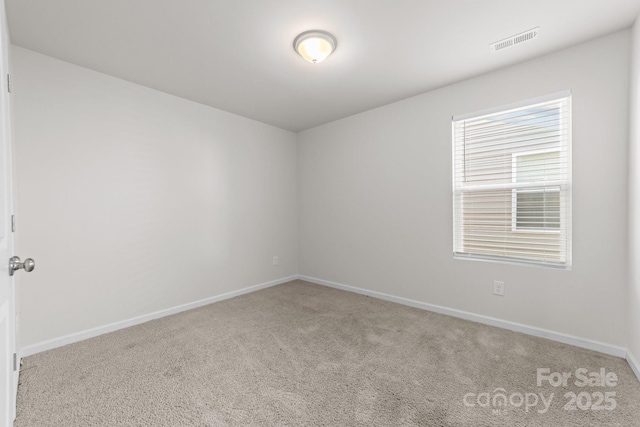 empty room featuring light carpet