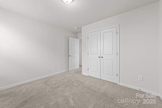 unfurnished bedroom with a closet and carpet