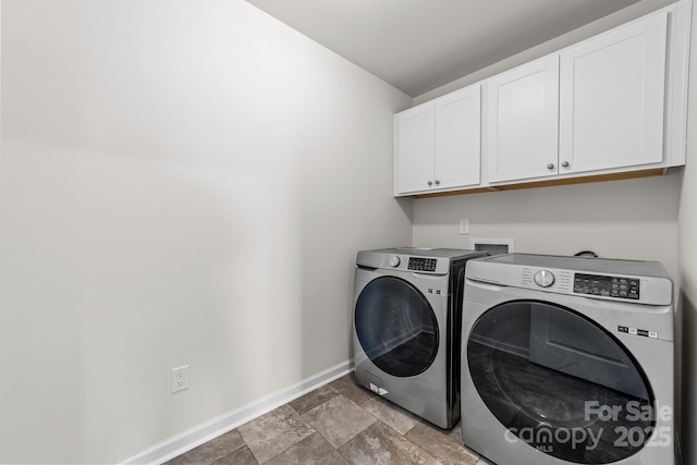 washroom with cabinets and washing machine and dryer