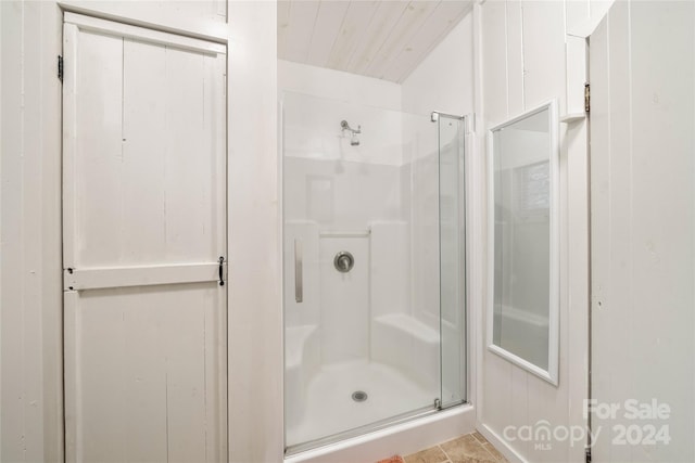 bathroom featuring a shower with door