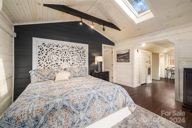 bedroom featuring lofted ceiling with skylight, dark hardwood / wood-style floors, wood walls, and wooden ceiling