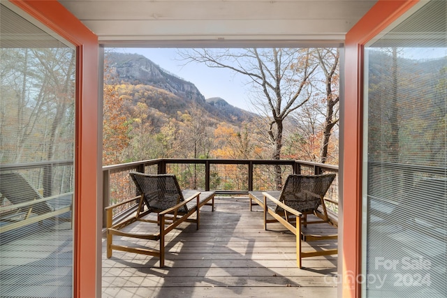 unfurnished sunroom with a mountain view