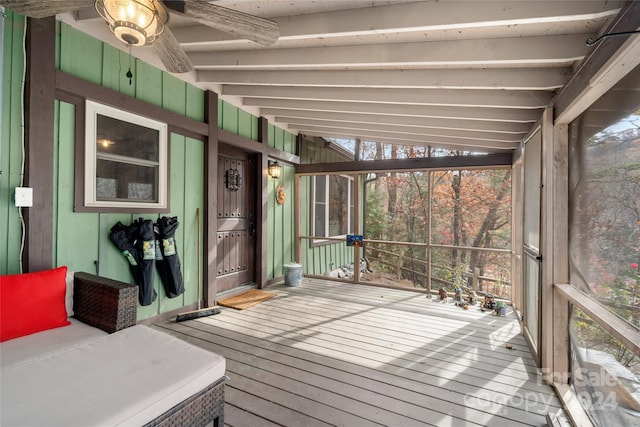 sunroom / solarium featuring ceiling fan and vaulted ceiling