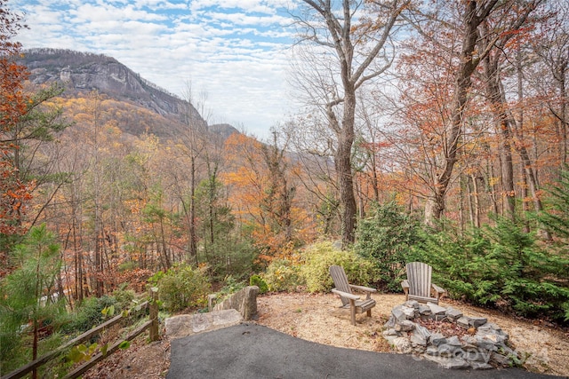 view of patio / terrace with a mountain view and a fire pit