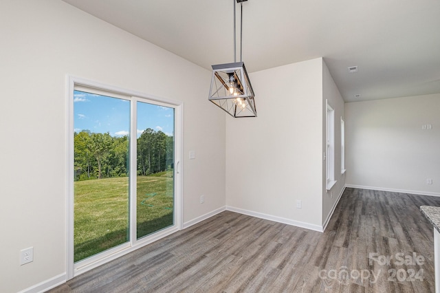 unfurnished dining area with wood-type flooring