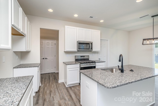 kitchen with appliances with stainless steel finishes, white cabinetry, and sink