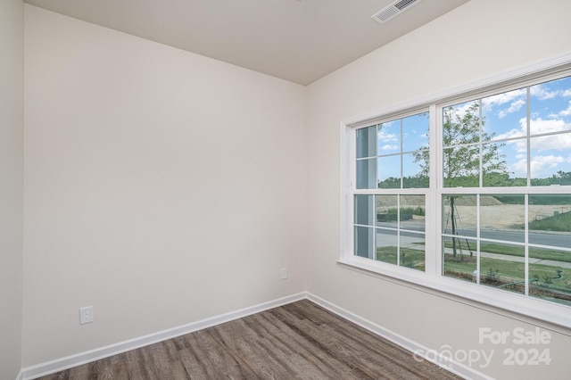 unfurnished room with hardwood / wood-style floors