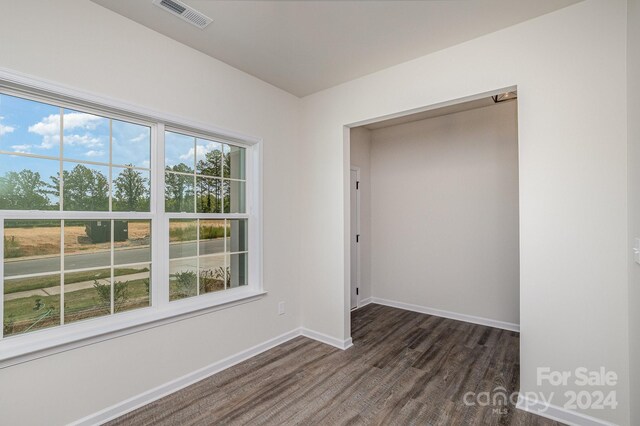 spare room featuring dark hardwood / wood-style flooring