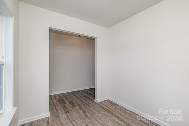 unfurnished bedroom with dark wood-type flooring