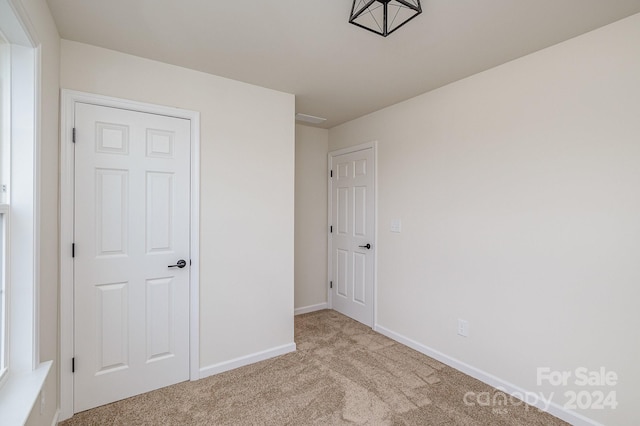 unfurnished bedroom featuring light colored carpet