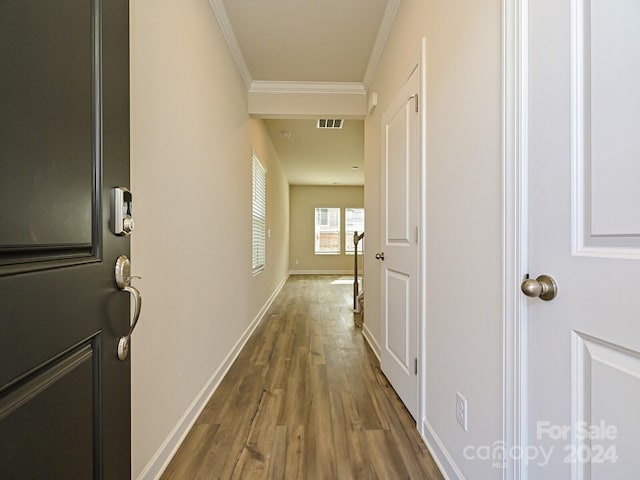 hallway featuring ornamental molding and dark wood-type flooring