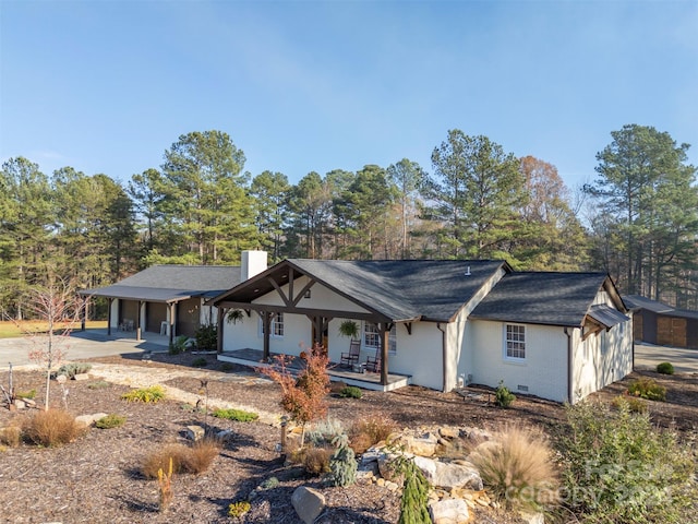 view of front of home featuring a porch and a garage