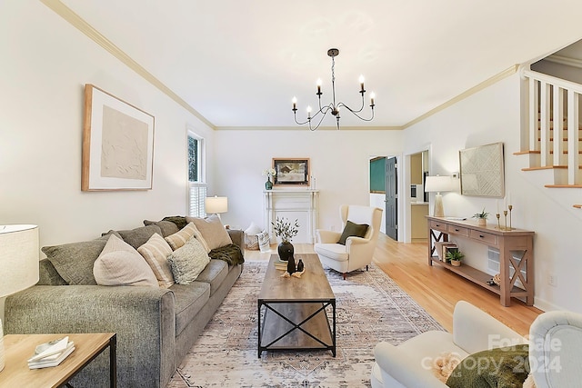 living room featuring ornamental molding, light hardwood / wood-style flooring, and a notable chandelier