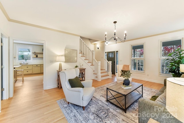 living room featuring crown molding, light hardwood / wood-style flooring, and a notable chandelier