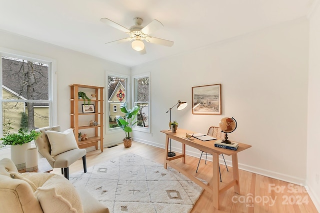 sitting room featuring ceiling fan, a healthy amount of sunlight, and light hardwood / wood-style floors