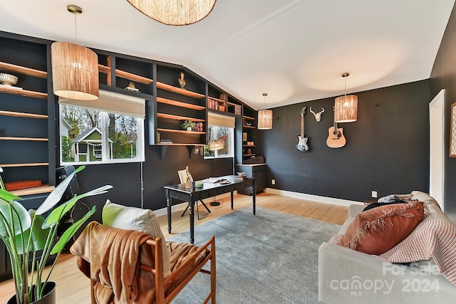 home office featuring hardwood / wood-style flooring and vaulted ceiling