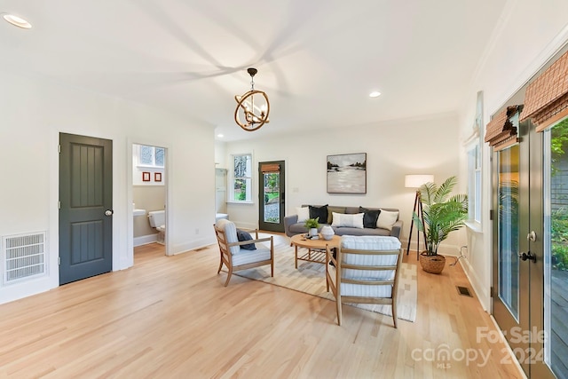 living room featuring light hardwood / wood-style flooring and a chandelier