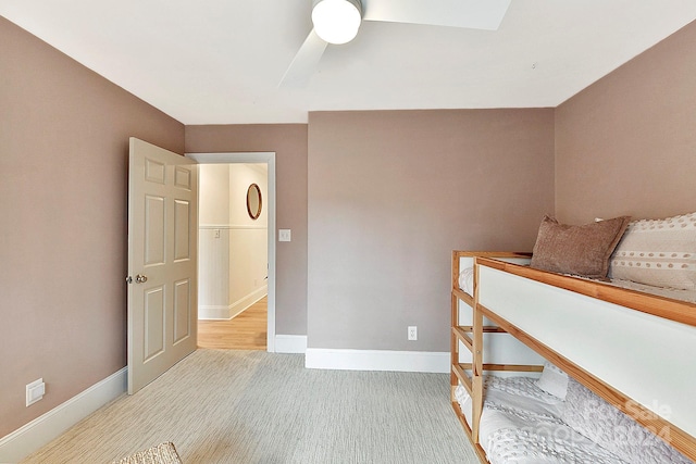 unfurnished bedroom with ceiling fan, light colored carpet, and a skylight